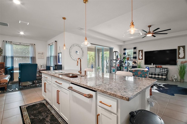 kitchen with open floor plan, a sink, light tile patterned flooring, ceiling fan, and dishwasher