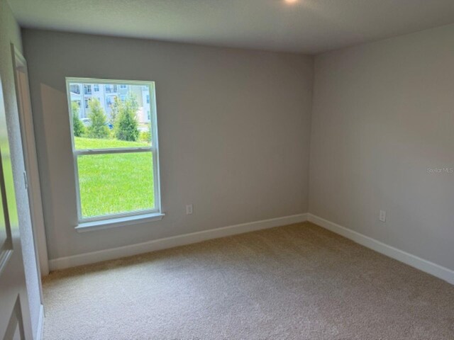2166 NW 23rd Loop, Ocala, FL 34475 - unfurnished room with carpet floors and baseboards
