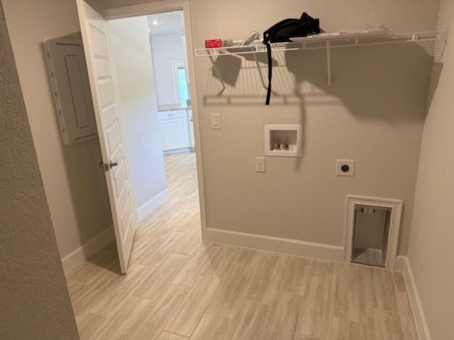 2166 NW 23rd Loop, Ocala, FL 34475 - washroom featuring washer hookup, light wood-style floors, baseboards, and hookup for an electric dryer