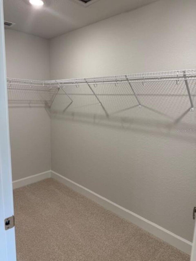 2166 NW 23rd Loop, Ocala, FL 34475 - spacious closet featuring carpet flooring