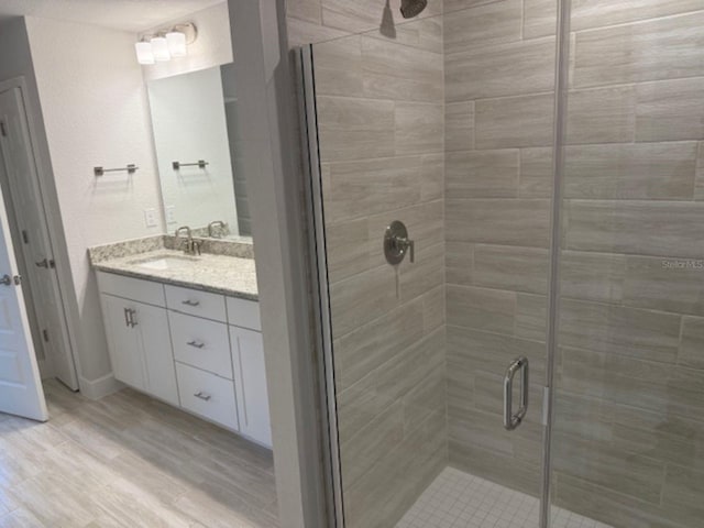 2166 NW 23rd Loop, Ocala, FL 34475 - bathroom with a shower stall, wood finished floors, and vanity