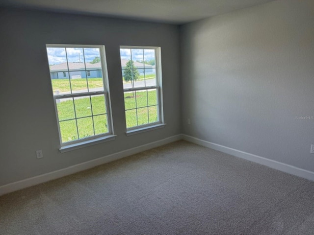 2166 NW 23rd Loop, Ocala, FL 34475 - carpeted empty room featuring baseboards and plenty of natural light