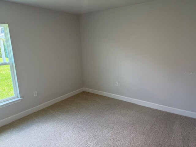 2166 NW 23rd Loop, Ocala, FL 34475 - spare room with light carpet and baseboards