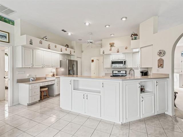 kitchen with white cabinetry, visible vents, arched walkways, and appliances with stainless steel finishes