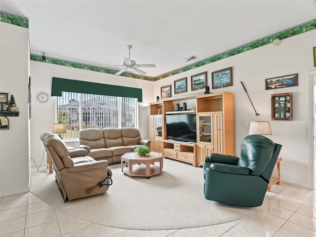 living room with a ceiling fan, tile patterned flooring, baseboards, and visible vents