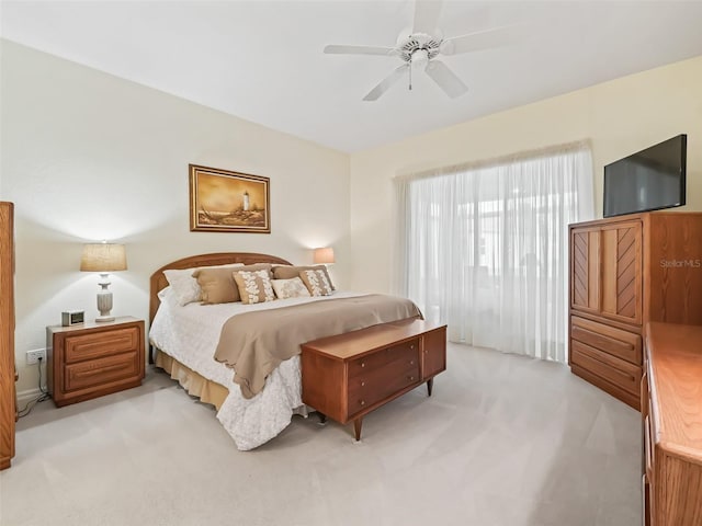 bedroom featuring a ceiling fan and light colored carpet