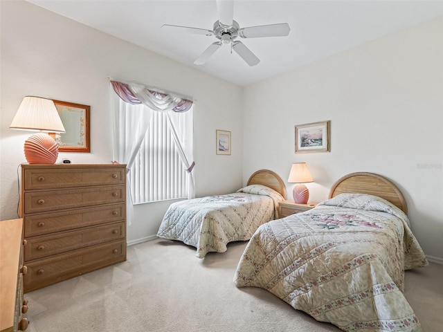 carpeted bedroom featuring baseboards and a ceiling fan