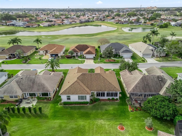 aerial view with golf course view, a water view, and a residential view