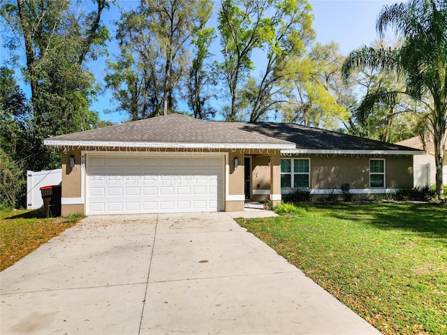 4575 SE 137th Pl, Summerfield, FL 34491 - single story home featuring stucco siding, roof with shingles, driveway, a front yard, and a garage