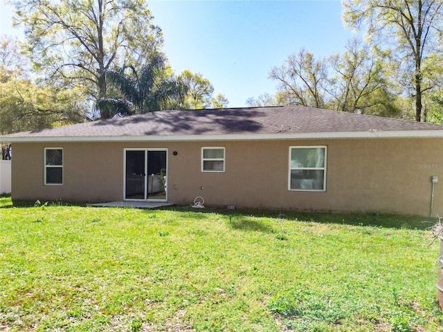 4575 SE 137th Pl, Summerfield, FL 34491 - back of house with a lawn and stucco siding