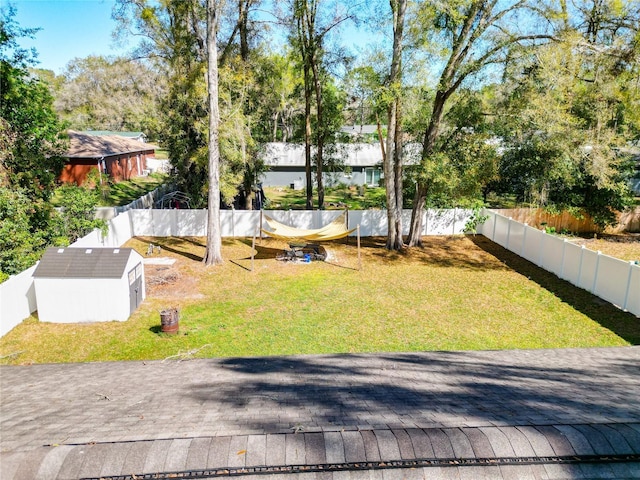 4575 SE 137th Pl, Summerfield, FL 34491 - view of yard featuring a fenced backyard, an outbuilding, and a storage unit