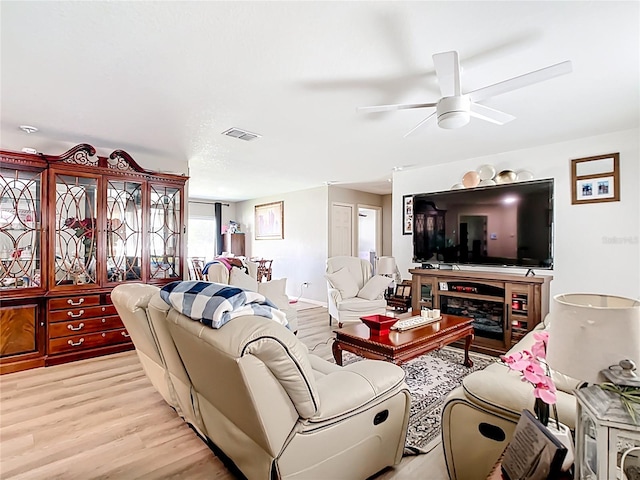 4575 SE 137th Pl, Summerfield, FL 34491 - living room with light wood finished floors, visible vents, and a ceiling fan