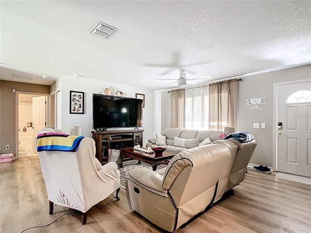 4575 SE 137th Pl, Summerfield, FL 34491 - living room featuring visible vents, ceiling fan, light wood-type flooring, and a textured ceiling