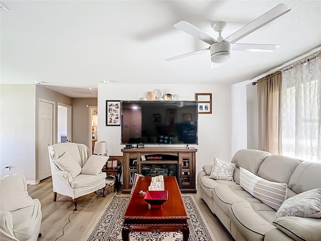 4575 SE 137th Pl, Summerfield, FL 34491 - living room with a fireplace, light wood finished floors, and ceiling fan