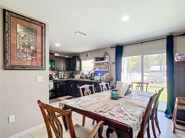 4575 SE 137th Pl, Summerfield, FL 34491 - dining room with visible vents, a textured wall, and light tile patterned floors
