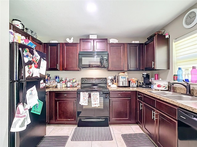4575 SE 137th Pl, Summerfield, FL 34491 - kitchen with reddish brown cabinets, light countertops, a sink, light tile patterned floors, and black appliances