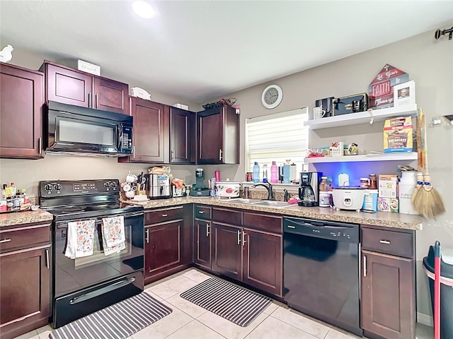 4575 SE 137th Pl, Summerfield, FL 34491 - kitchen with black appliances, light countertops, a sink, and light tile patterned floors