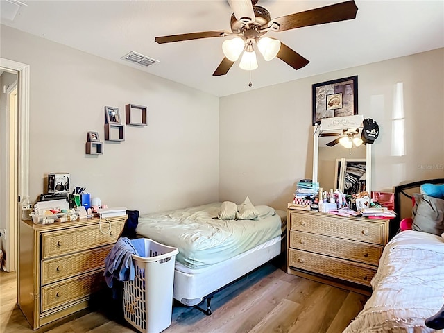 4575 SE 137th Pl, Summerfield, FL 34491 - bedroom with a ceiling fan, visible vents, and wood finished floors