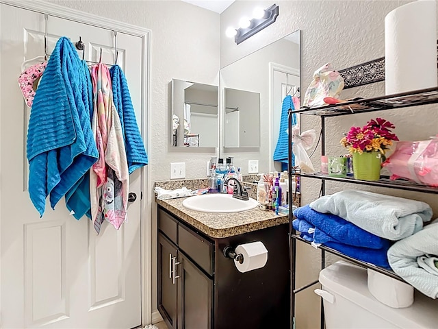 4575 SE 137th Pl, Summerfield, FL 34491 - bathroom featuring toilet, vanity, and a textured wall