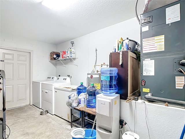 4575 SE 137th Pl, Summerfield, FL 34491 - laundry room featuring washing machine and clothes dryer, heating unit, a textured ceiling, and laundry area