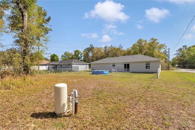 5056 NW 61st Ave, Ocala, FL 34482 - rear view of property featuring an outdoor pool, fence, and a yard