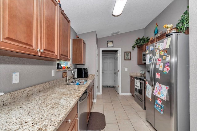 5056 NW 61st Ave, Ocala, FL 34482 - kitchen featuring a sink, brown cabinets, stainless steel appliances, light tile patterned floors, and visible vents