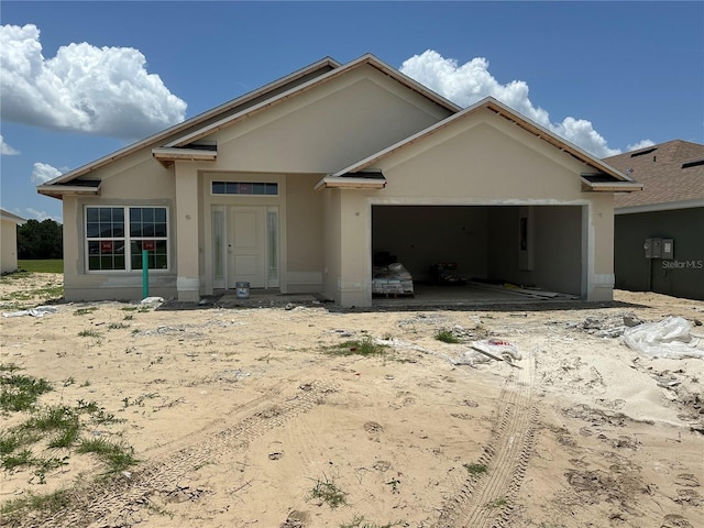 4522 SW 90th Lane Rd, Ocala, FL 34476 - view of front of home with an attached garage, stucco siding, and driveway