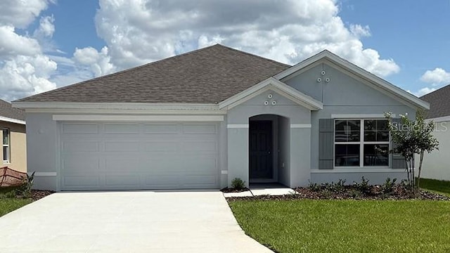 4754 SW 88th Ln, Ocala, FL 34476 - view of front of home with roof with shingles, concrete driveway, a garage, and stucco siding