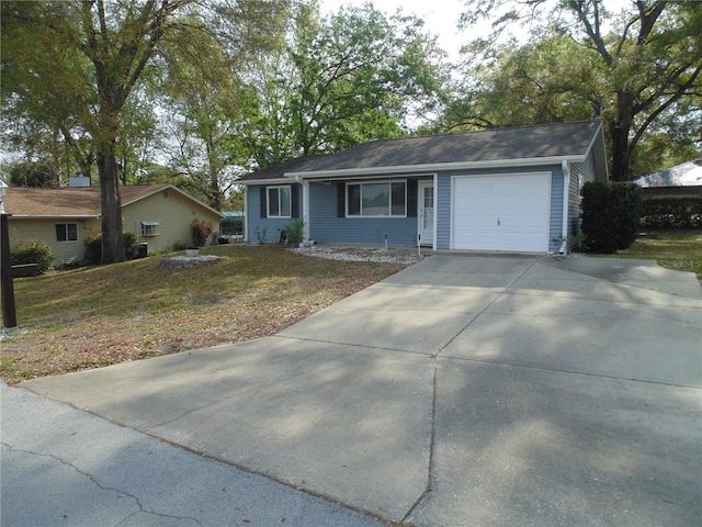 single story home with an attached garage, driveway, and a front lawn
