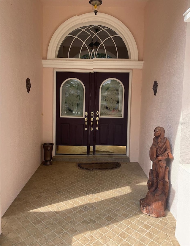 entrance to property with stucco siding and french doors