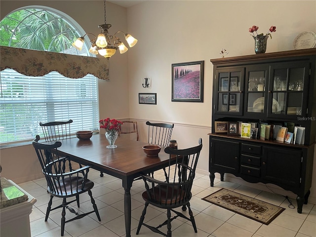 dining area with light tile patterned floors and a chandelier