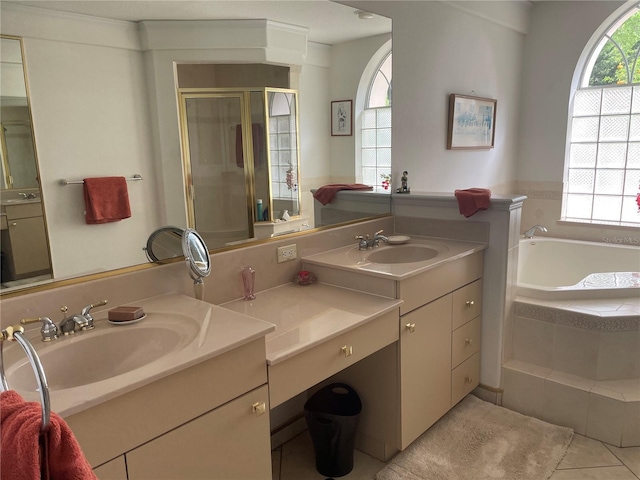 full bath featuring tile patterned flooring, vanity, a garden tub, and a shower stall