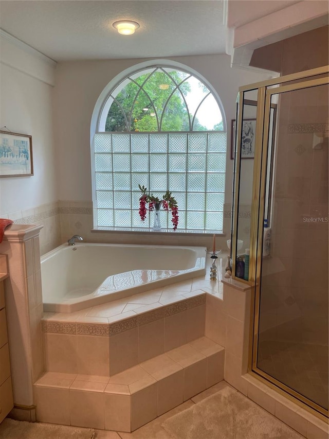 full bath with a bath and a shower stall