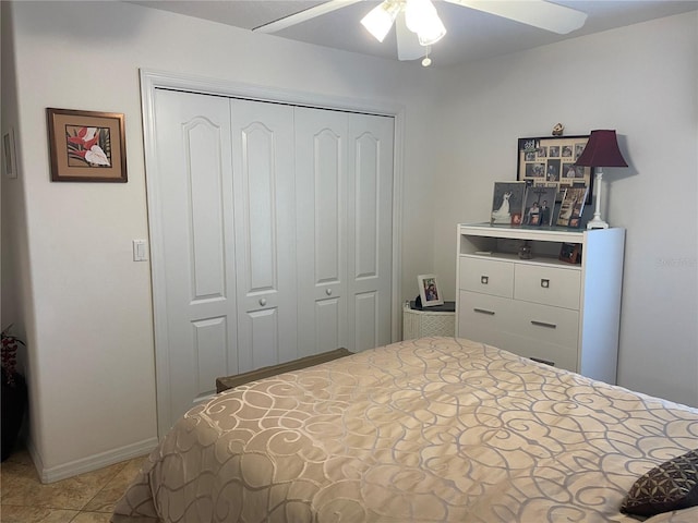 bedroom with tile patterned floors, a closet, and ceiling fan