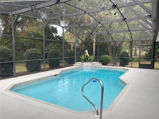 pool with glass enclosure and a patio area