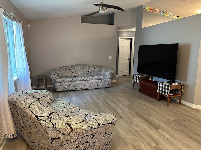 6082 SW 104th St, Ocala, FL 34476 - living room with baseboards, ceiling fan, light wood-style flooring, and lofted ceiling
