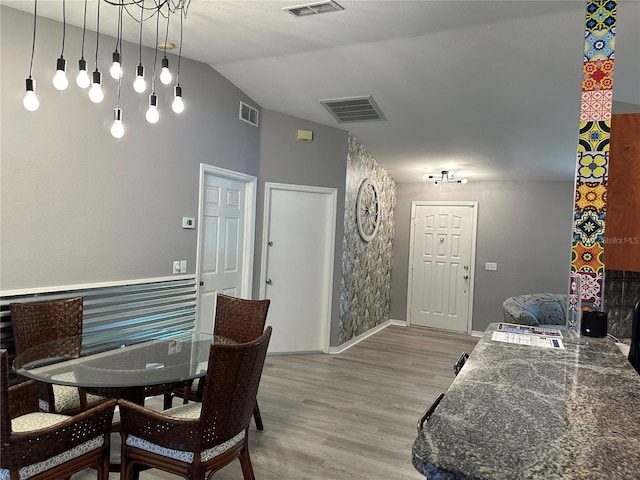 6082 SW 104th St, Ocala, FL 34476 - dining area with light wood-style floors, vaulted ceiling, and baseboards