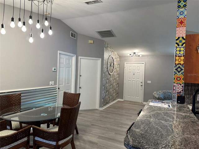 6082 SW 104th St, Ocala, FL 34476 - dining area featuring light wood-type flooring, vaulted ceiling, and baseboards