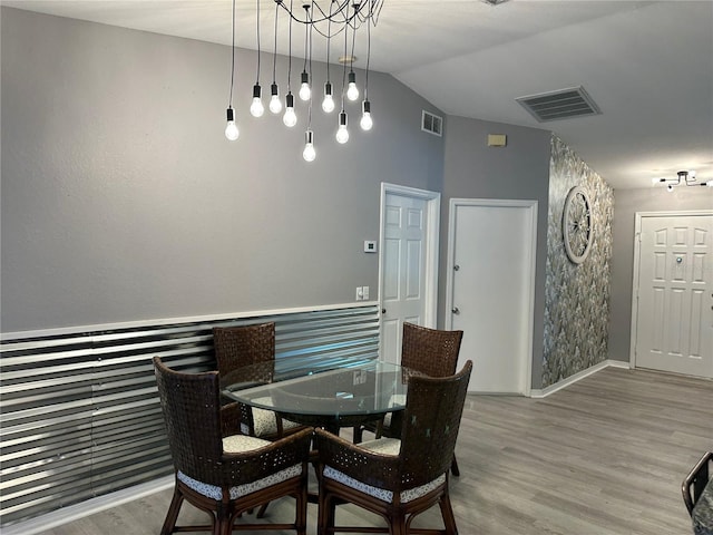 6082 SW 104th St, Ocala, FL 34476 - dining area featuring wood finished floors, lofted ceiling, and baseboards