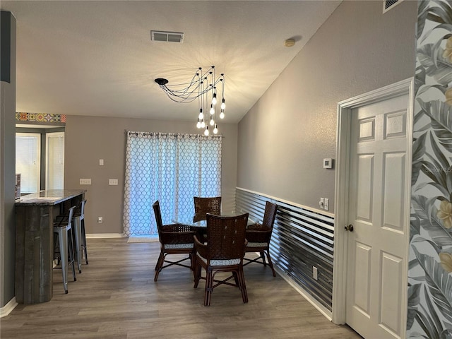 6082 SW 104th St, Ocala, FL 34476 - dining space with wood finished floors, a chandelier, and baseboards