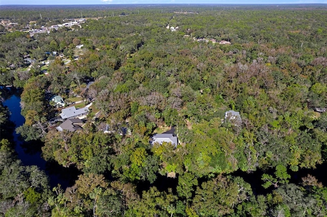 birds eye view of property featuring a wooded view and a water view