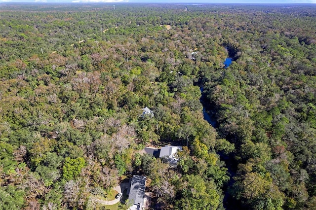 bird's eye view with a wooded view