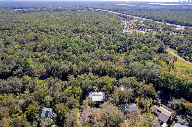 birds eye view of property featuring a view of trees