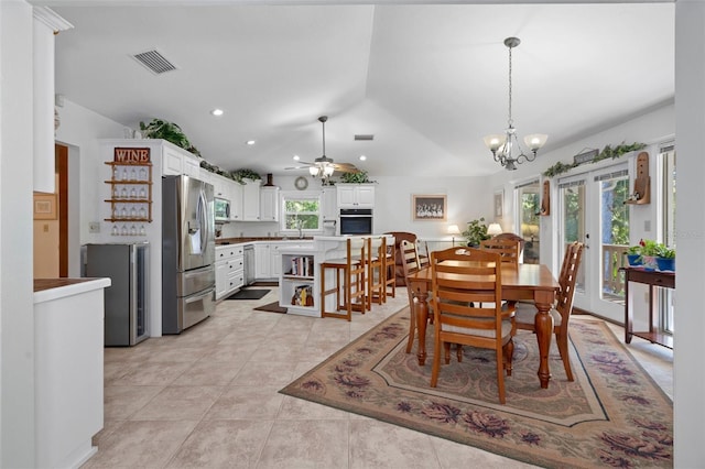 dining room featuring lofted ceiling, light tile patterned floors, ceiling fan with notable chandelier, visible vents, and recessed lighting