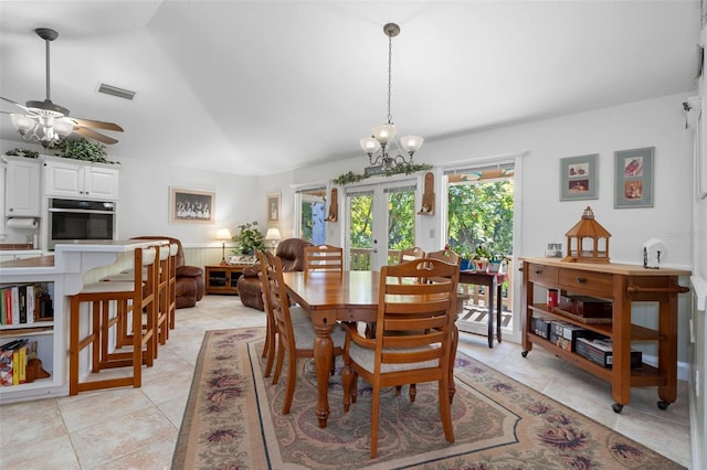 dining area with lofted ceiling, french doors, light tile patterned floors, ceiling fan with notable chandelier, and visible vents