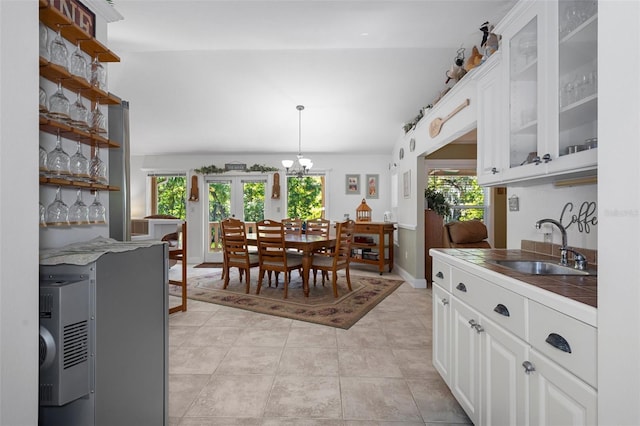 dining room with baseboards, a chandelier, and light tile patterned floors