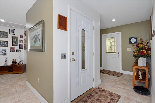 entryway with baseboards, recessed lighting, and light tile patterned floors