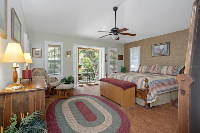 bedroom featuring a ceiling fan, access to outside, and wood finished floors