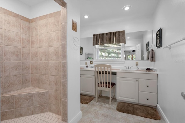 bathroom with recessed lighting, tiled shower, tile patterned flooring, and vanity