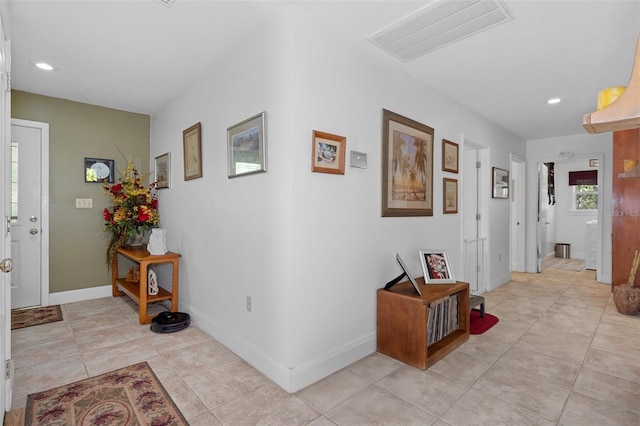 hall featuring baseboards, visible vents, recessed lighting, and light tile patterned floors